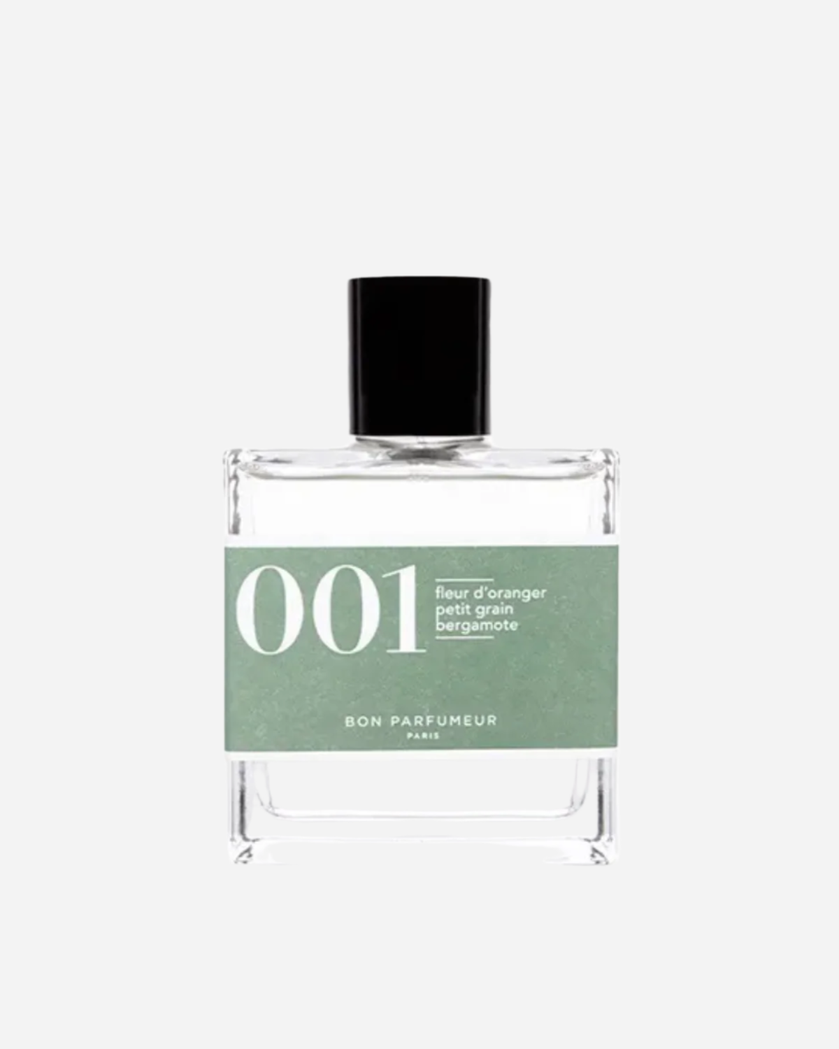 Clear square perfume bottle with black lid and green label