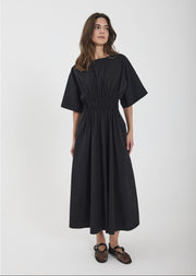 Woman wearing a black dress on a white background