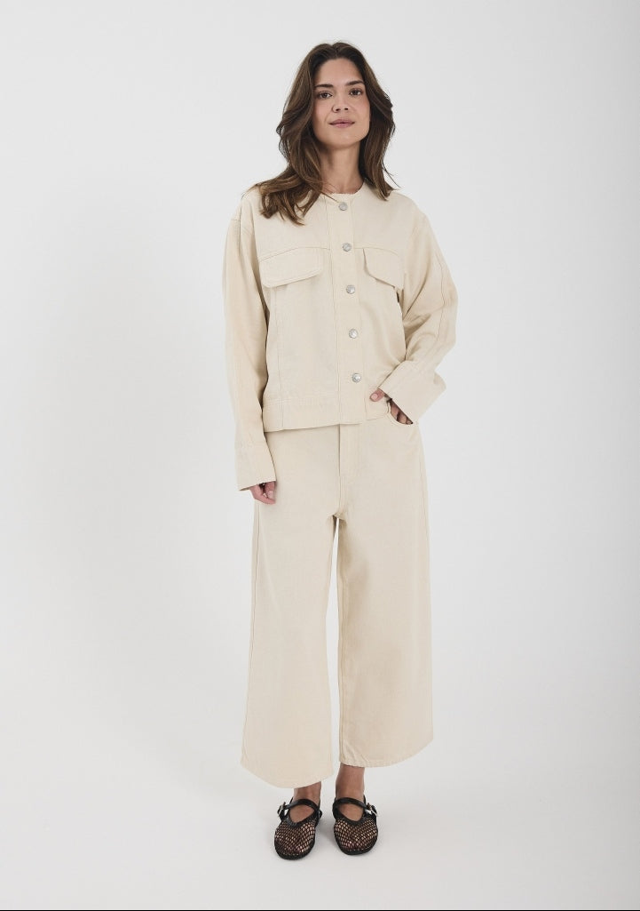 Woman wearing a beige outfit on a white background