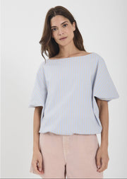 Woman wearing a light blue striped top