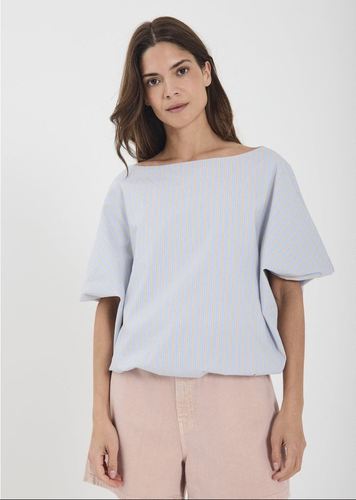 Woman wearing a light blue striped top