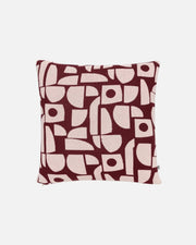 A square throw pillow featuring an abstract geometric pattern in deep burgundy and light pink, shown against a plain white background.