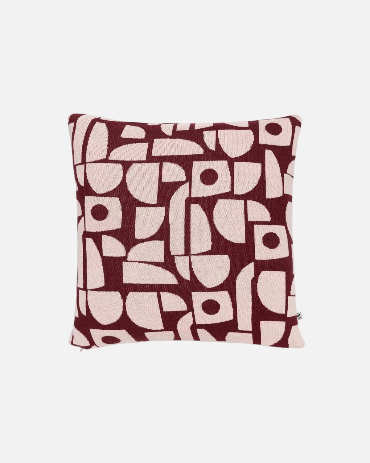 A square throw pillow featuring an abstract geometric pattern in deep burgundy and light pink, shown against a plain white background.