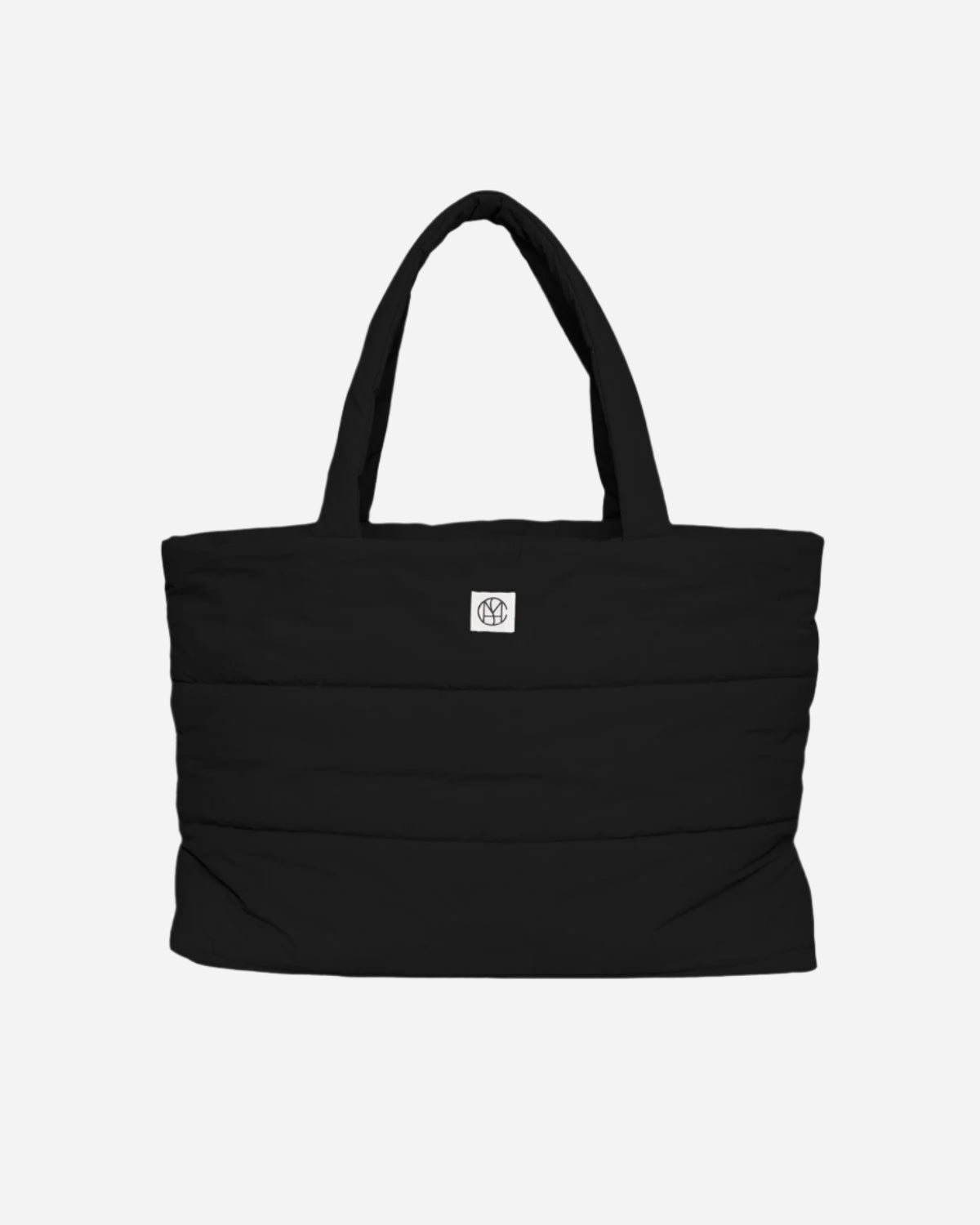 Black tote bag with a brand logo on a light gray background