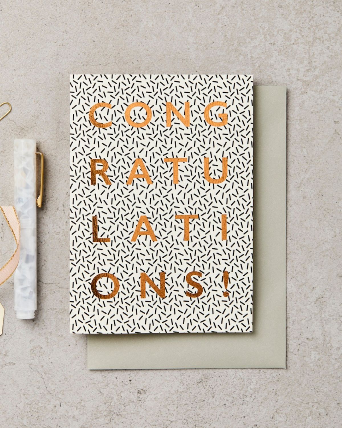Greeting card with 'Congratulations!' text on a textured surface