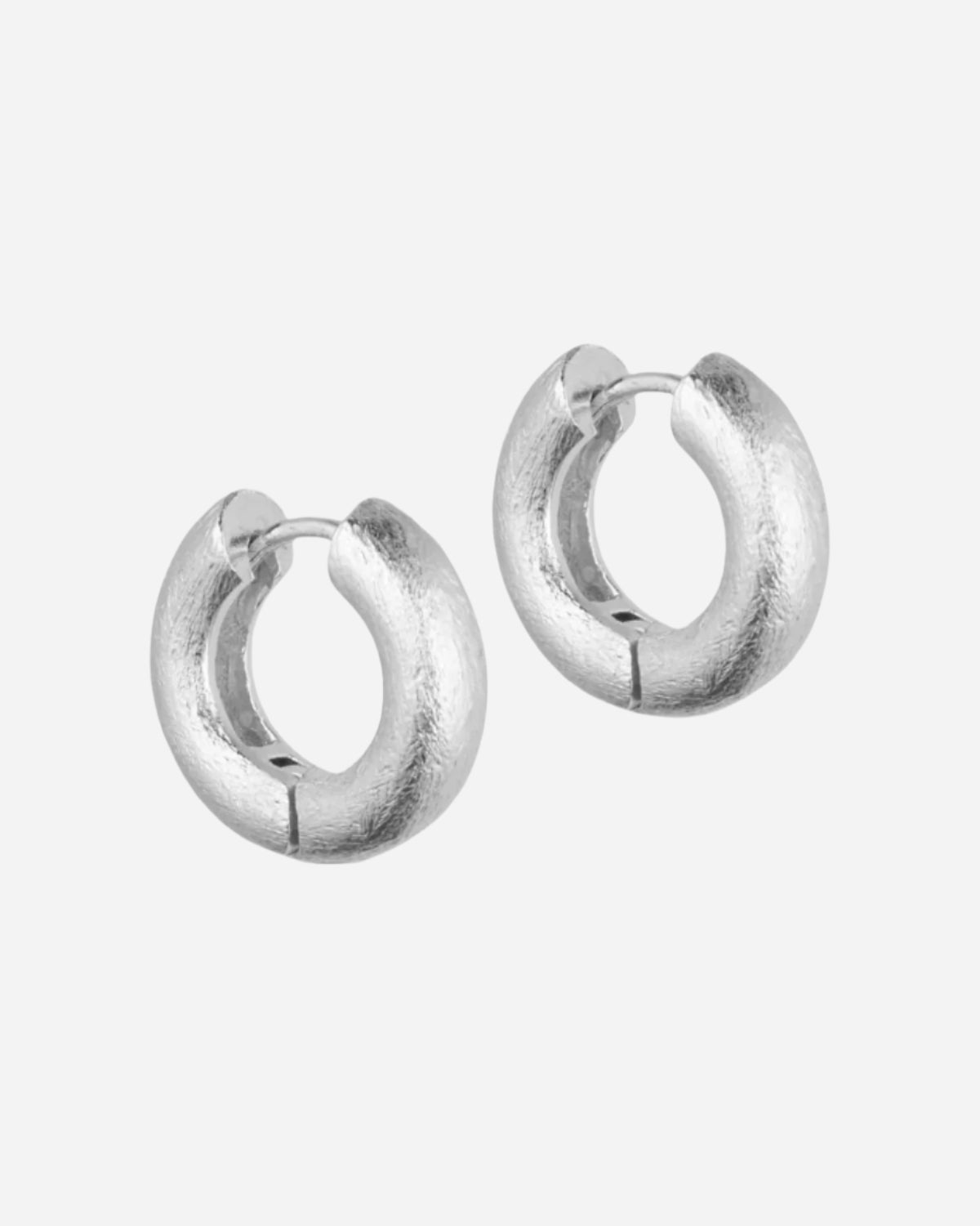 Pair of silver hoop earrings on a white background