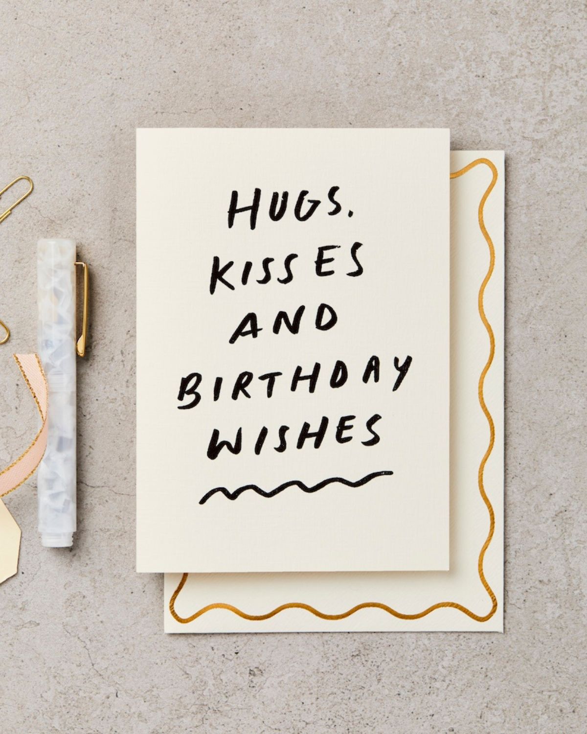 Greeting card with 'Hugs, Kisses and Birthday Wishes' text on a beige background