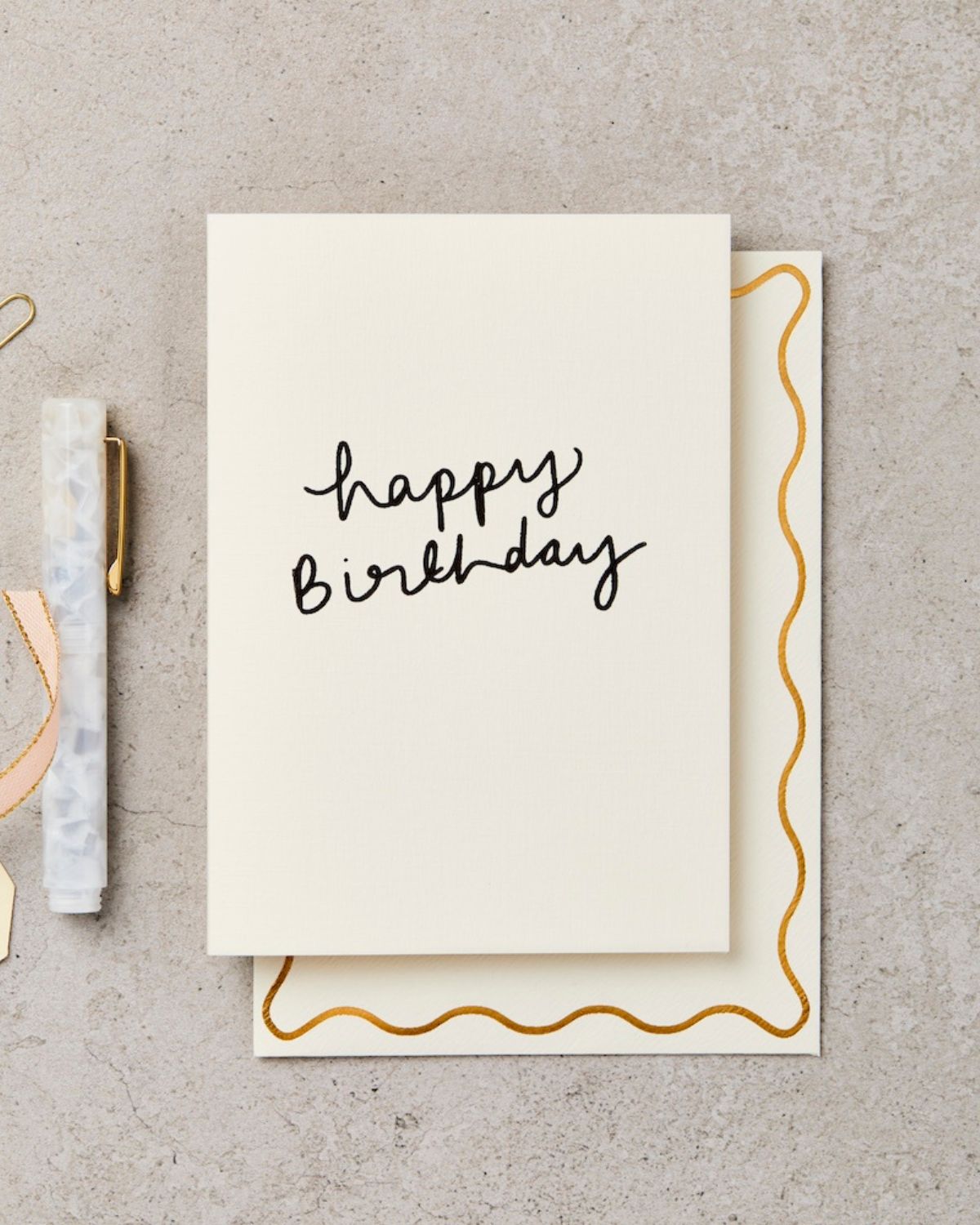 Birthday card with 'happy birthday' text on a textured surface