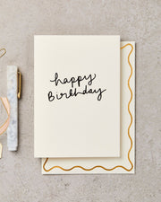 Birthday card with 'happy birthday' text on a textured surface