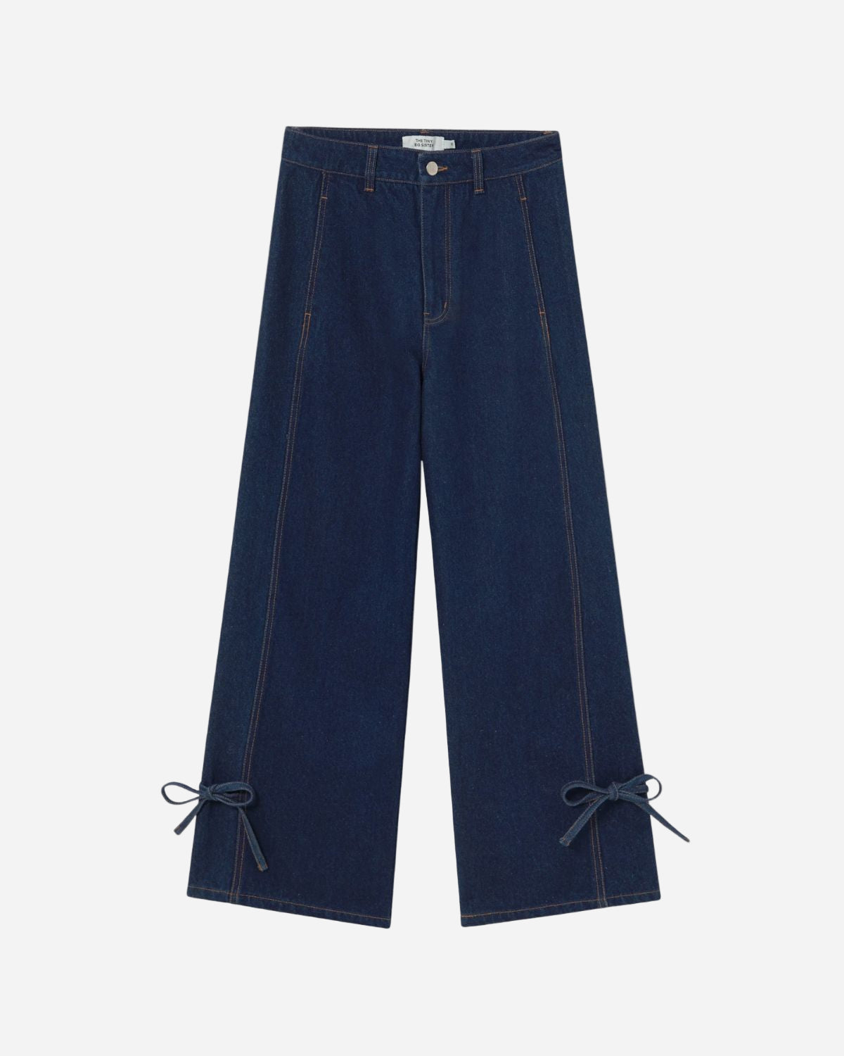 Pair of blue jeans with bow details on a white background