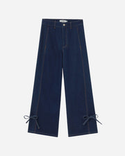 Pair of blue jeans with bow details on a white background