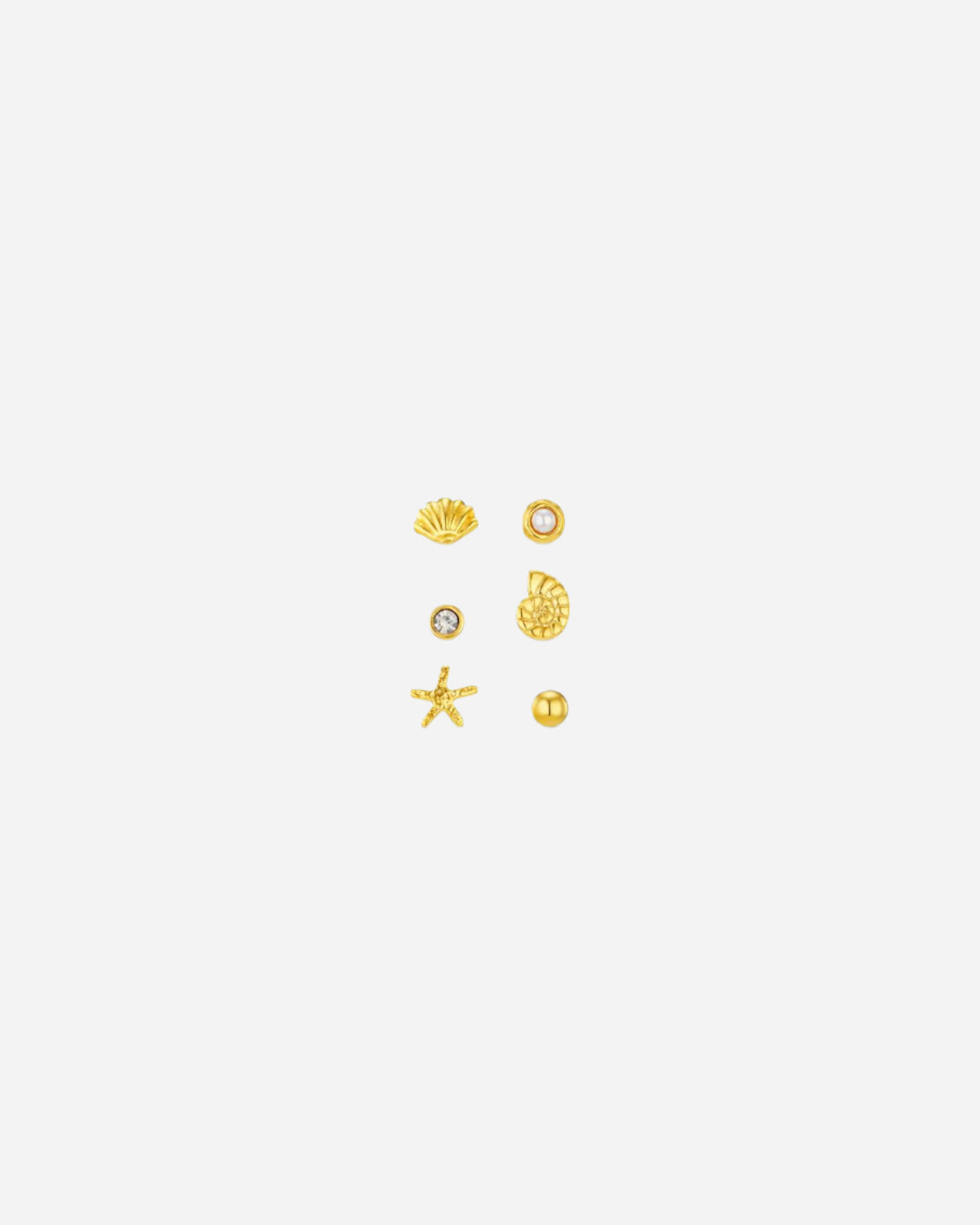 Set of gold ocean inspired earrings on a white background