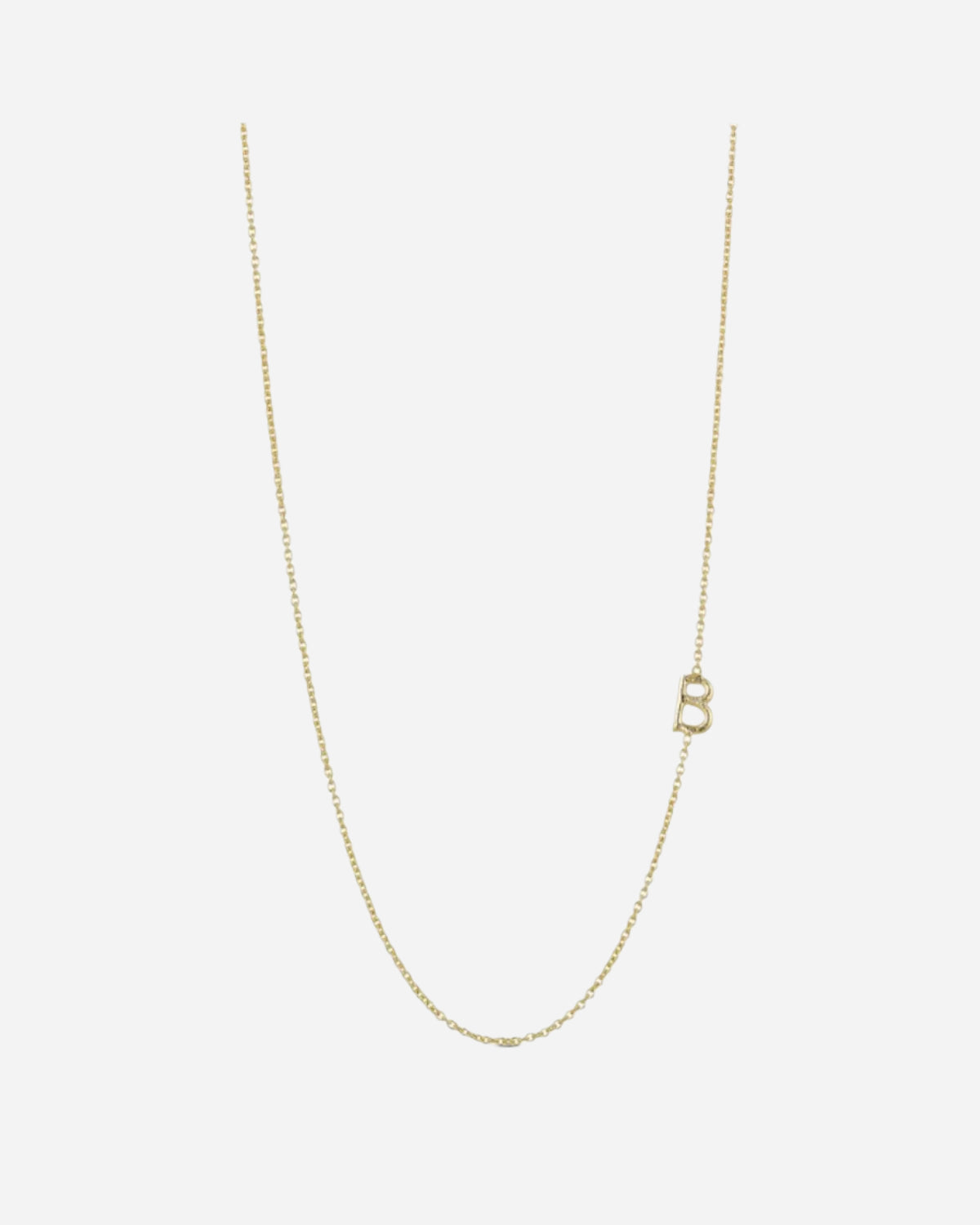 Gold necklace with a letter 'B' pendant on a light gray background