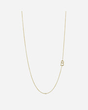 Gold necklace with a letter 'B' pendant on a light gray background