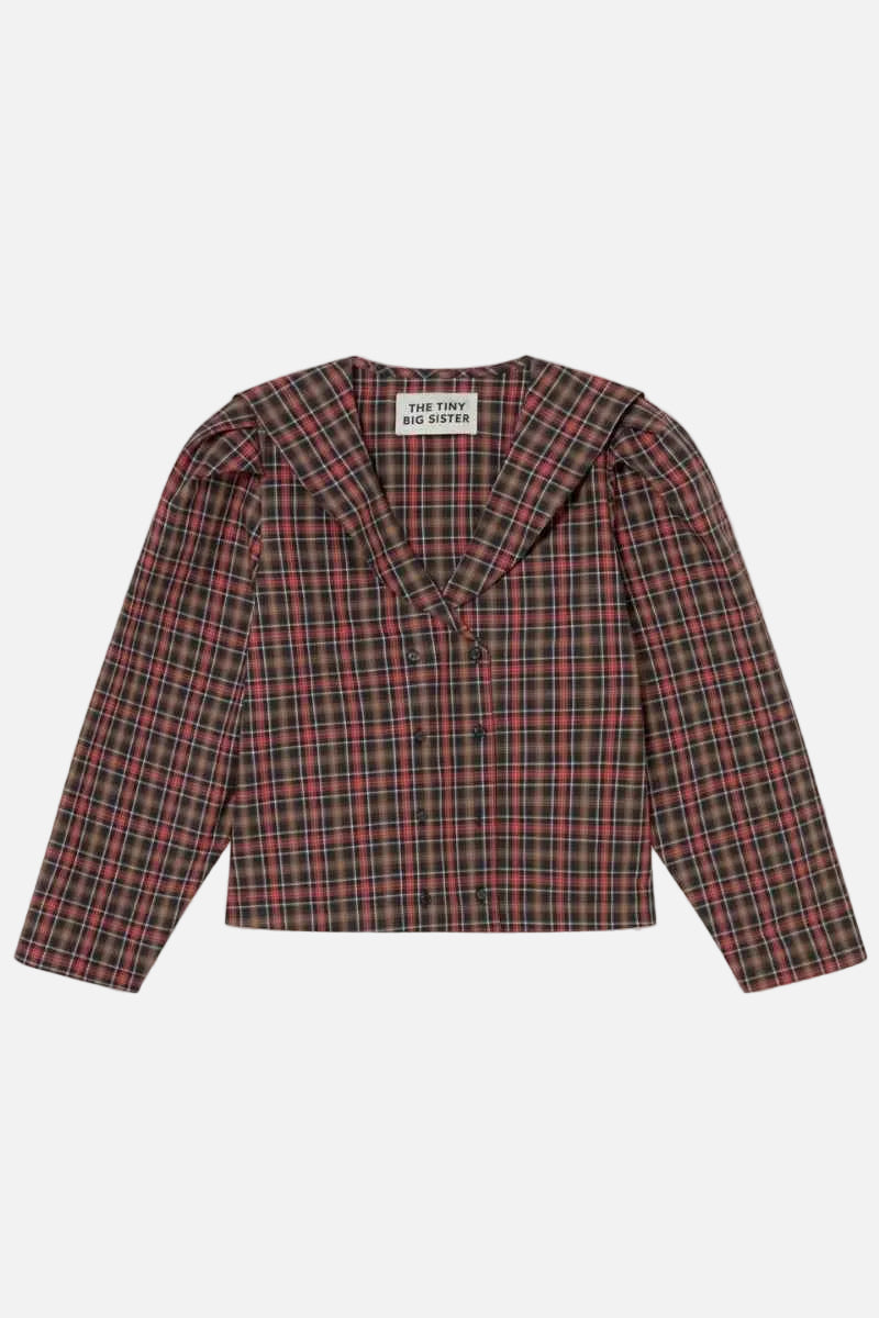 A cropped long-sleeve plaid top by New York and Sydney, featuring a red, green, and black tartan pattern with structured shoulders, laid flat against a light cream background.
