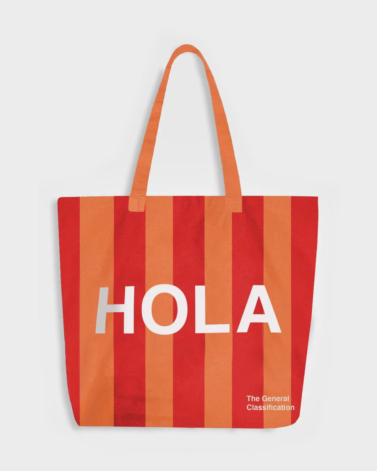 Red and orange striped tote bag with 'HOLA' text on a light gray background