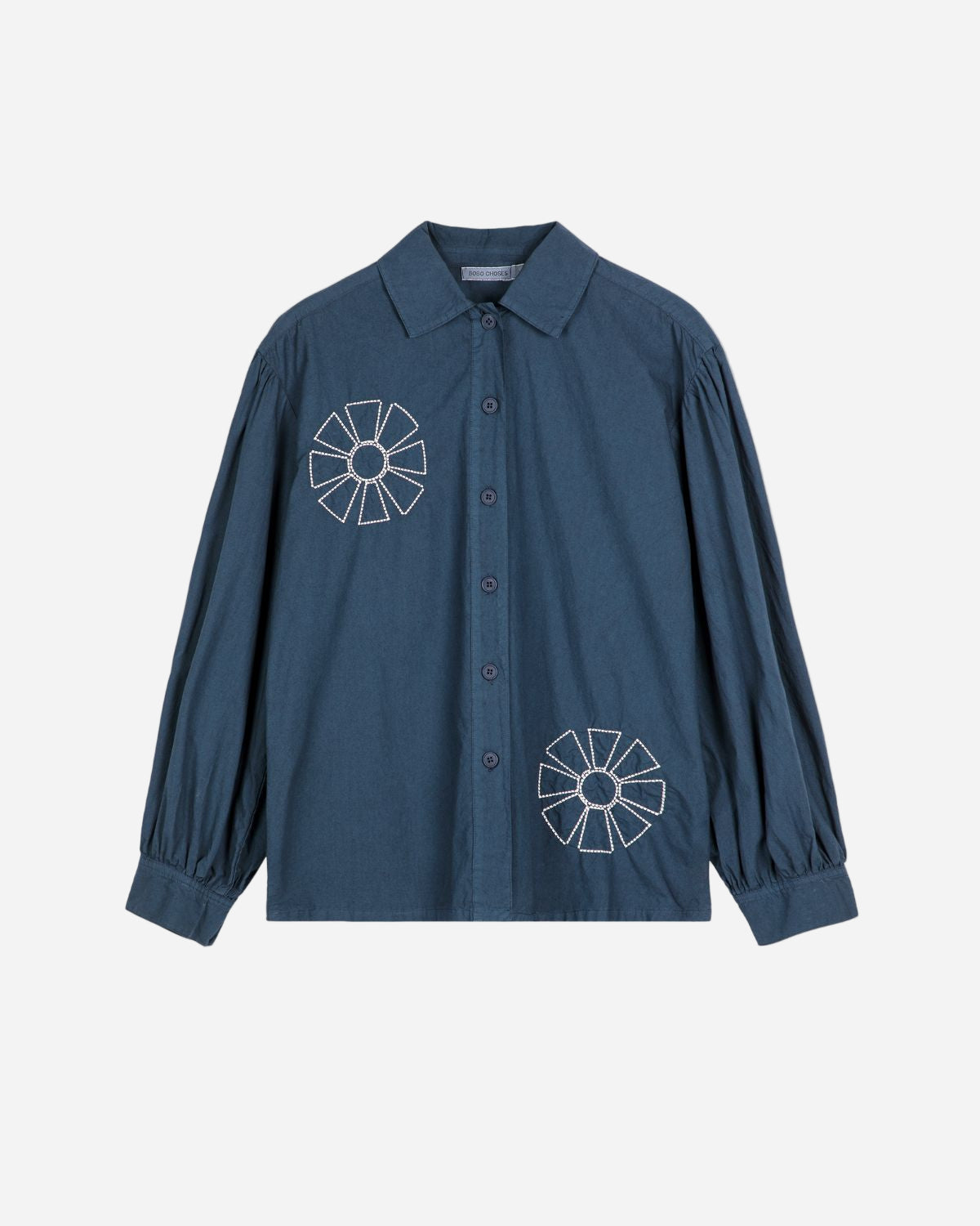 Blue shirt with white floral patterns on a white background