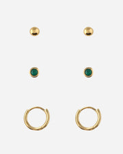 Set of gold earrings with green gemstones on a white background