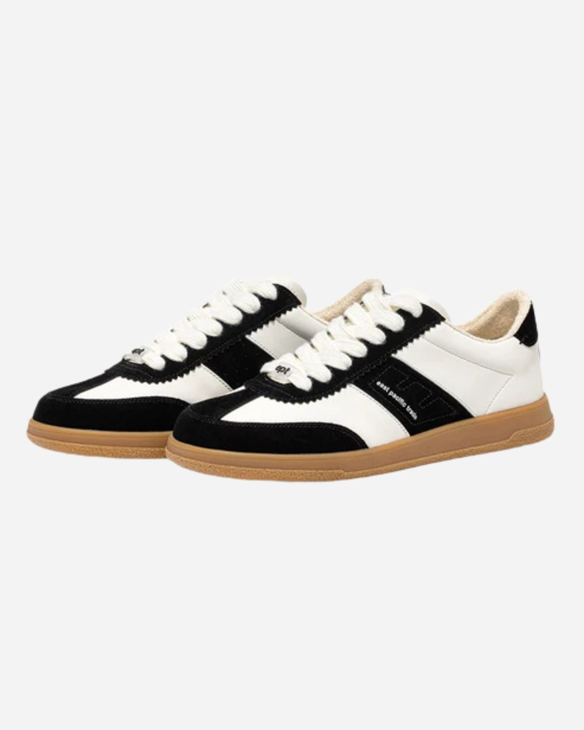 Black and white trainers with white laces and brown sole