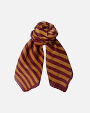 A lightweight scarf with diagonal stripes in maroon and mustard yellow, styled in a loose knot against a plain white background.