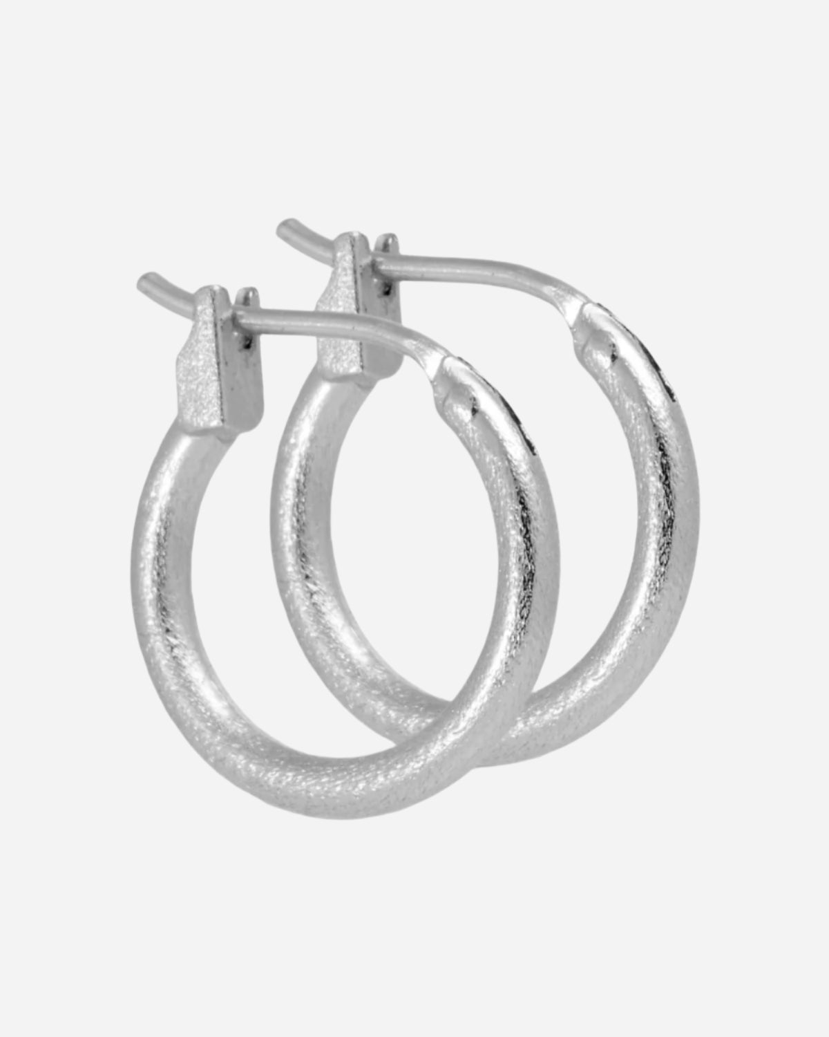 Pair of silver hoop earrings on a white background