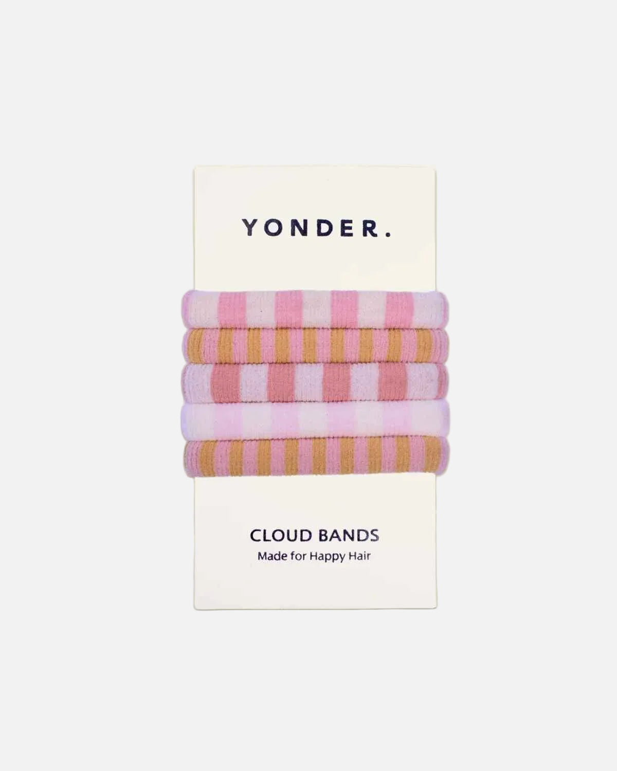 A set of four Yonder Cloud Bands in pastel pink, peach, lavender, and tan stripes, packaged on a white card with the brand name YONDER.