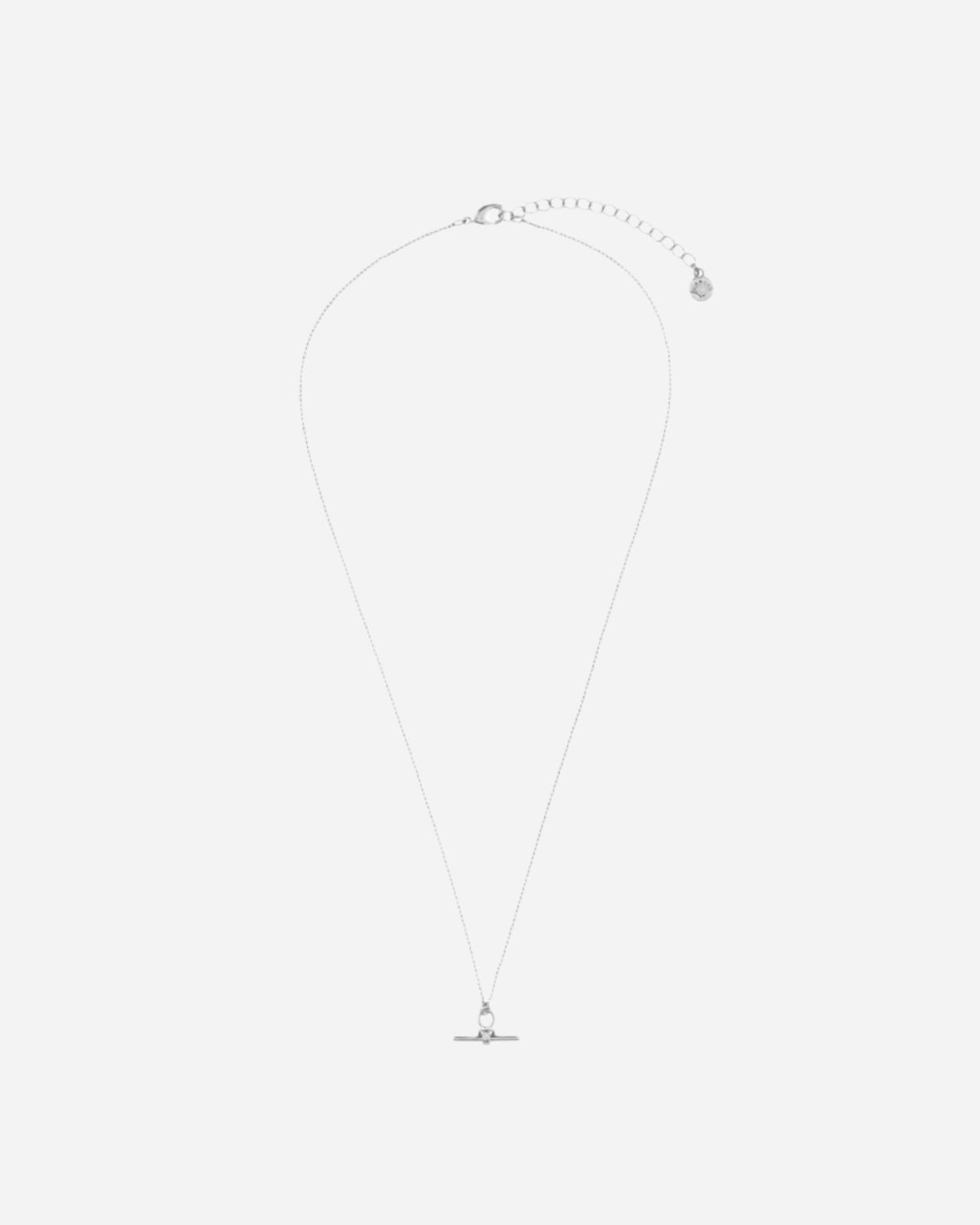 Silver necklace with a small pendant on a white background