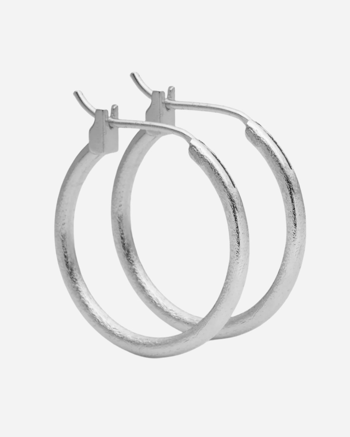 Pair of silver hoop earrings on a white background