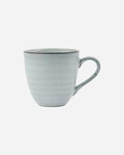 Light blue ceramic mug on a white background