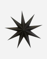 Black paper star decoration on a white background