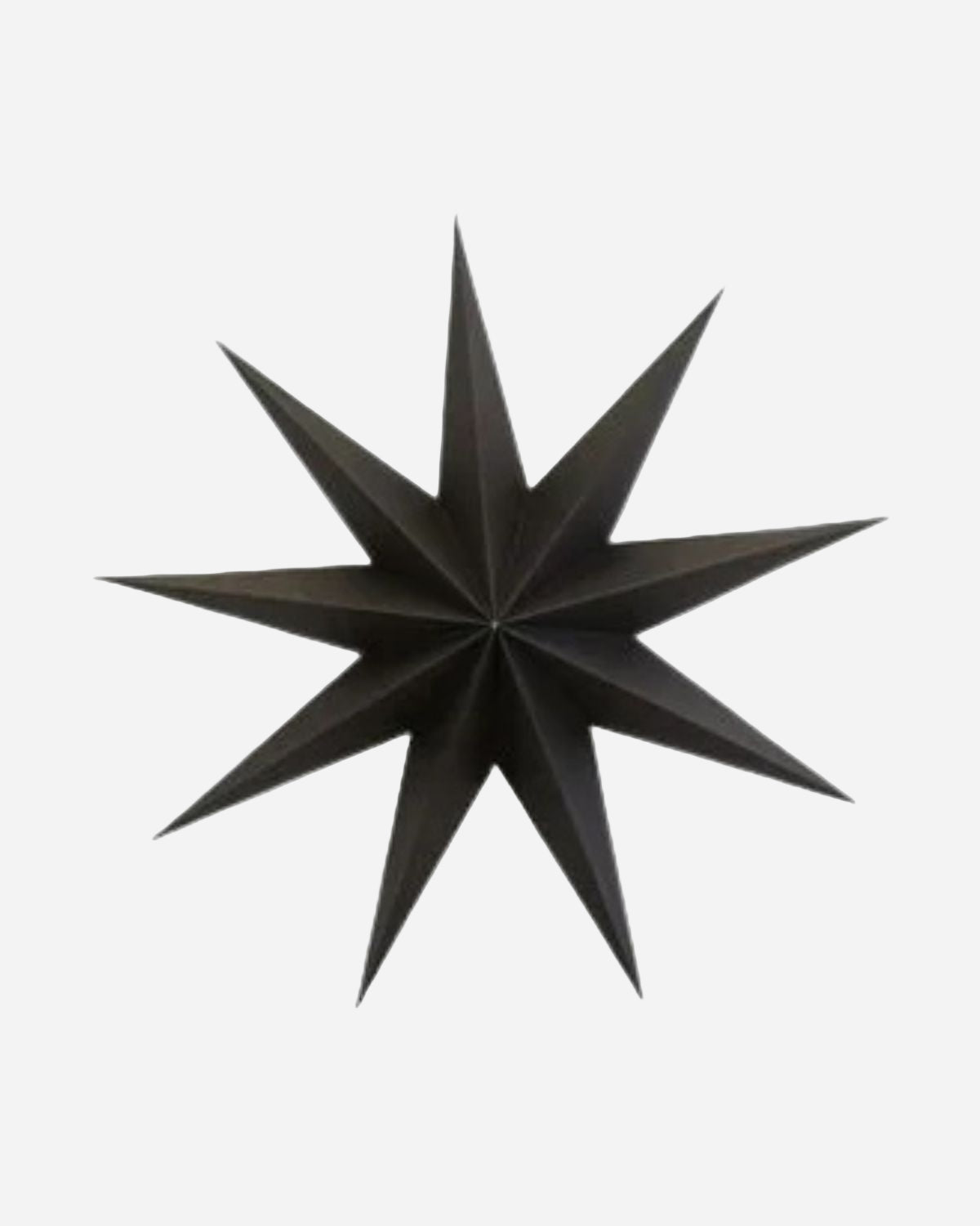 Black paper star decoration on a white background
