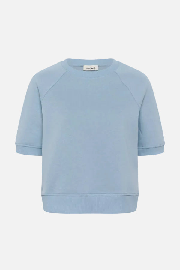 Light blue sweatshirt with a brand label on a white background