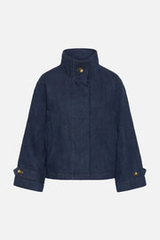 A denim blue cropped jacket with a high stand-up collar, front button closure, and buttoned cuffs, shown against a plain white background.