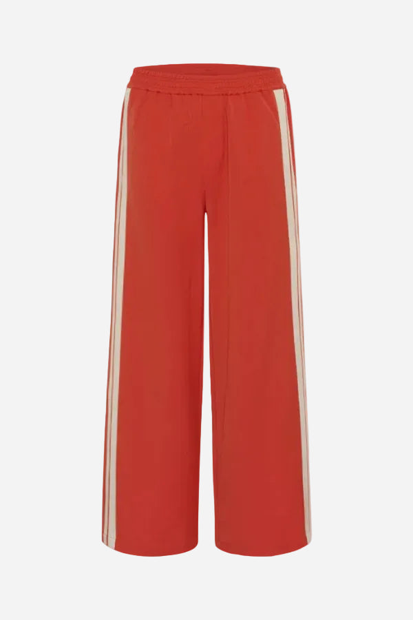 Red pants with white stripes on a white background