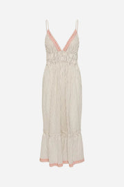 Beige pleated dress with coral trim on a white background