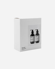 White box with two black bottles labeled 'meraki' on a white background