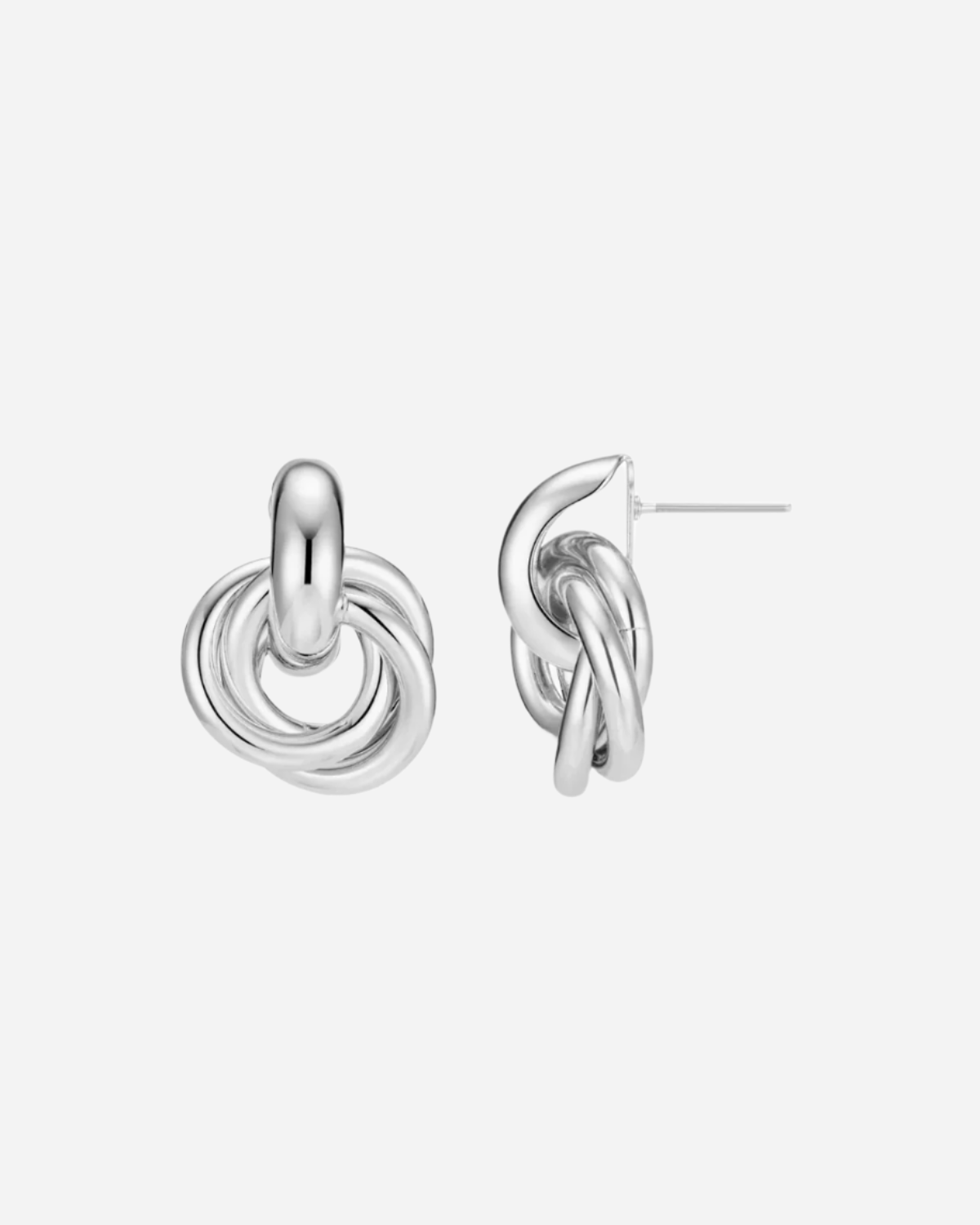 Pair of silver knot earrings on a white background