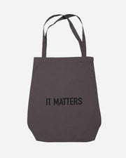 Gray tote bag with 'IT MATTERS' text on a white background