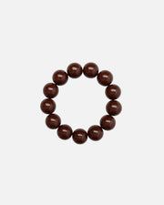A beaded bracelet made of glossy, dark brown round beads.