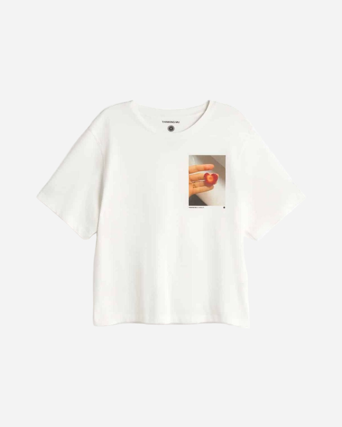 White t-shirt with a graphic of a hand holding a phone on a white background