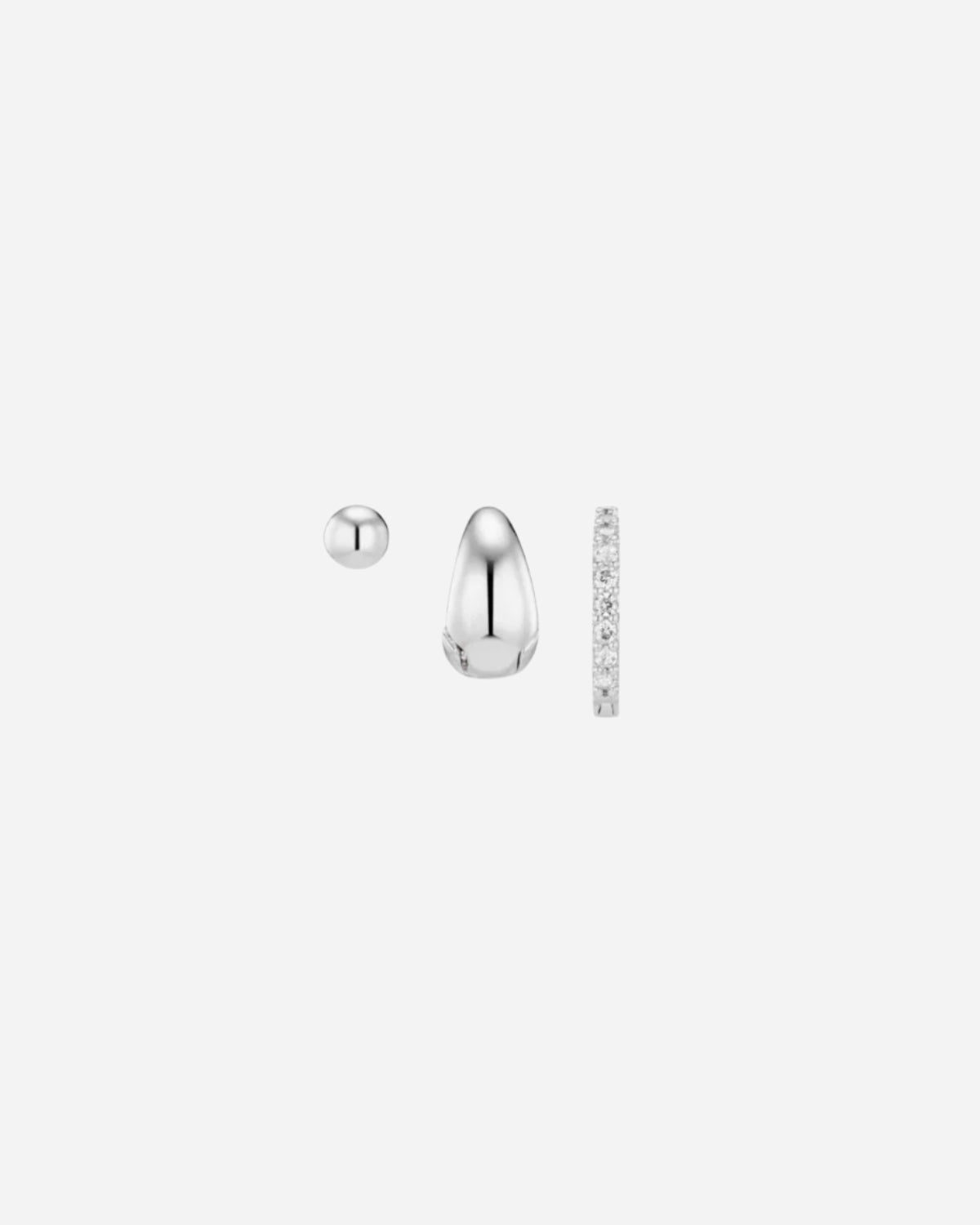 Pair of silver earrings with a ruler for scale on a white background