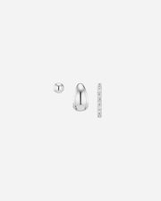 Pair of silver earrings with a ruler for scale on a white background