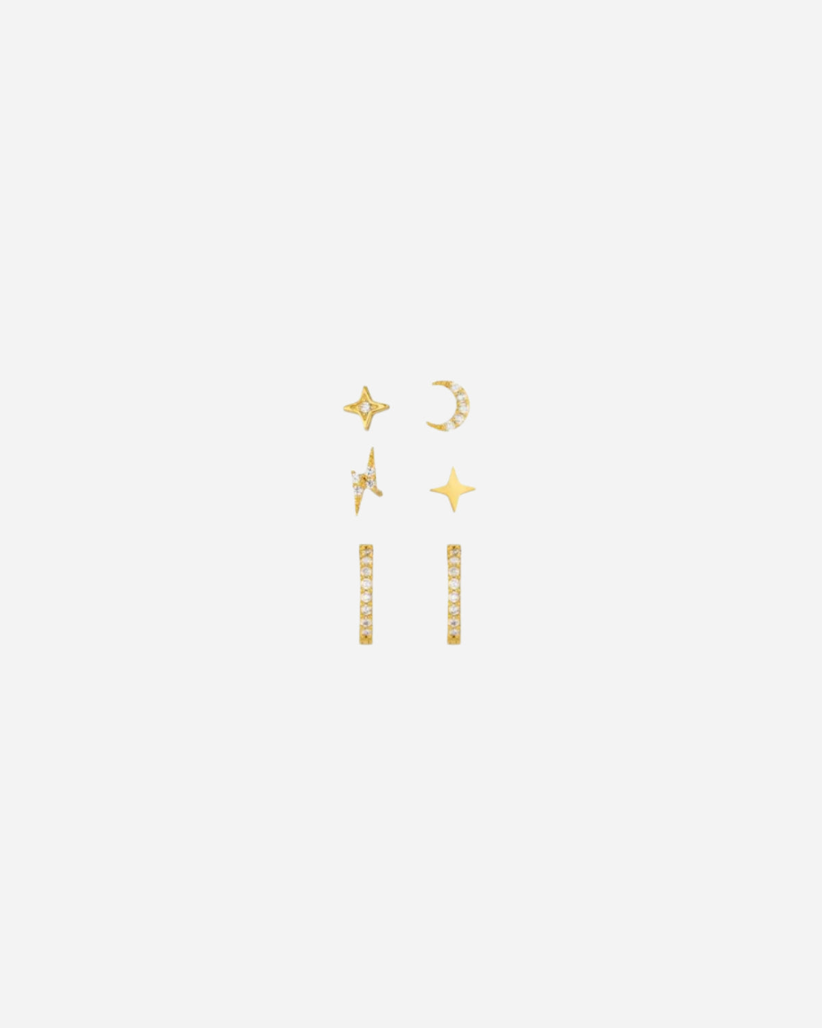 Set of gold earrings on a white background