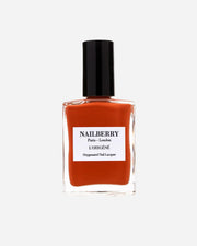 Nail polish bottle with black cap and orange-red liquid on a white background