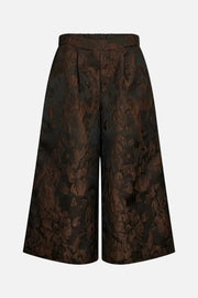 A pair of high-waisted, wide-leg cropped trousers featuring a dark brown and black floral jacquard pattern, shown against a plain white background.
