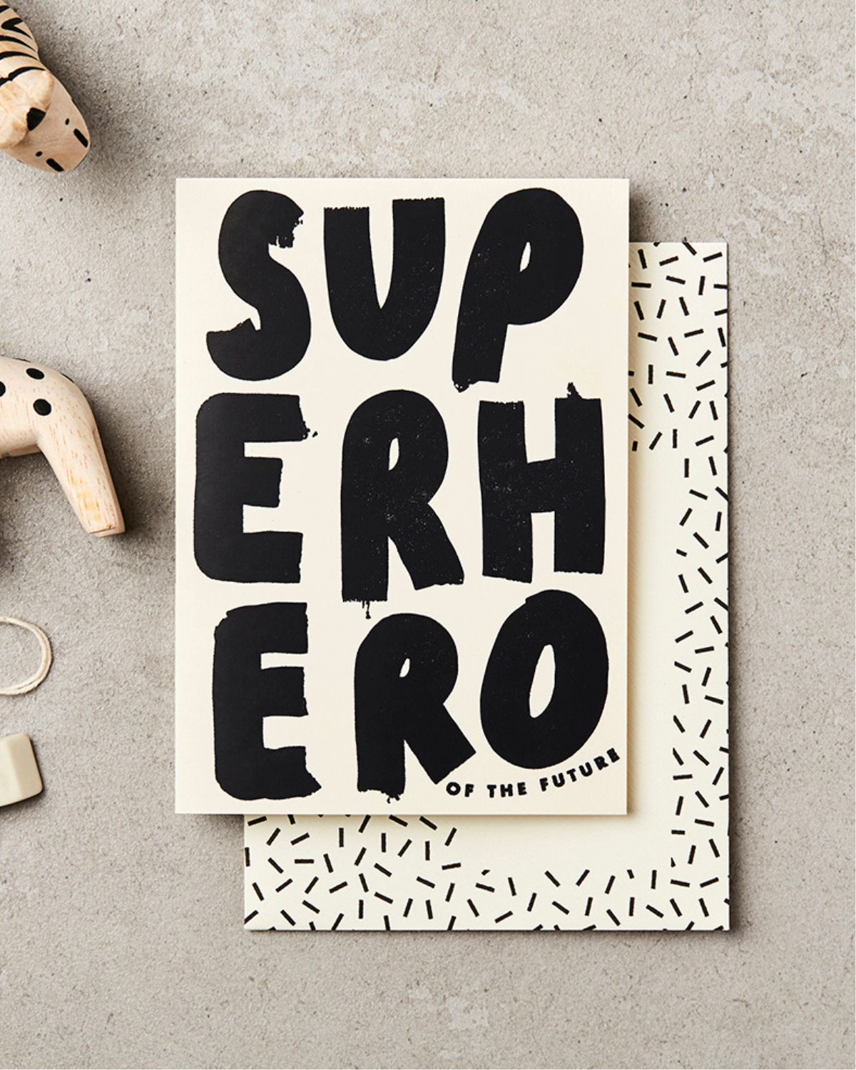 Poster with 'Superhero of the Future' text on a textured surface