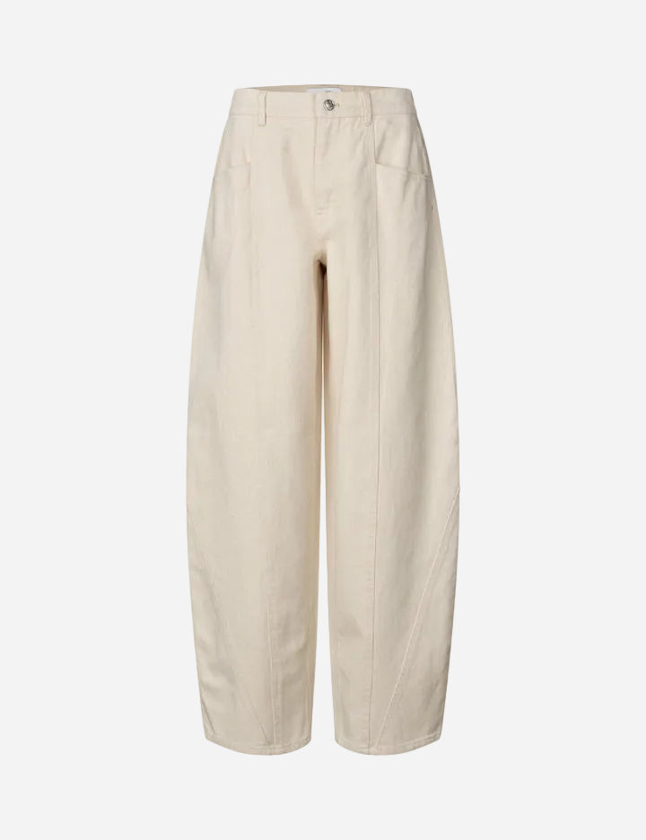 Beige barrel-leg jeans on a white background
