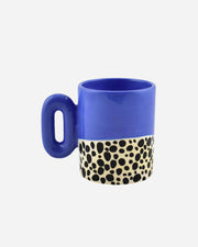 Blue mug with a spotted pattern on a white background