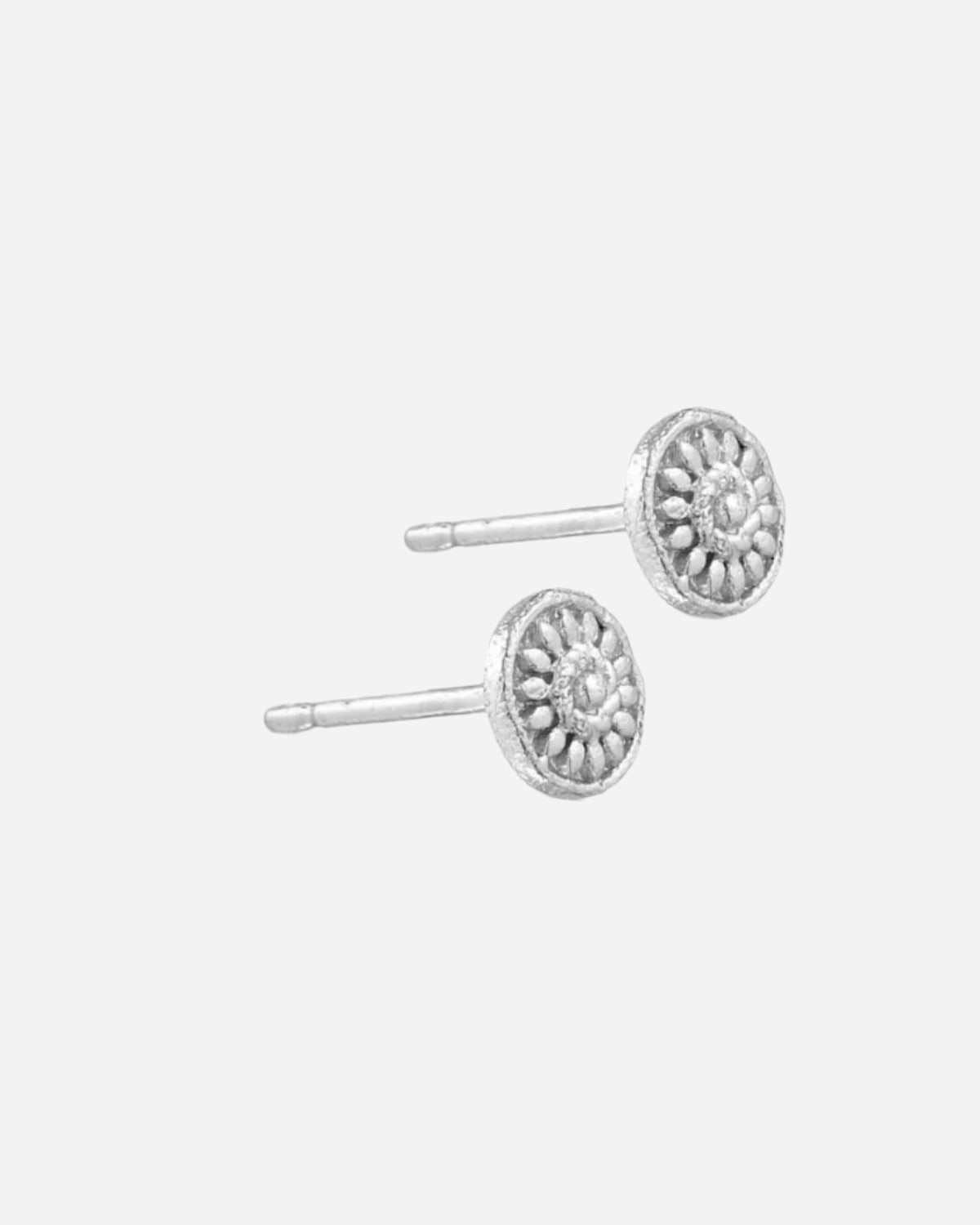 Silver earrings with intricate design on a white background