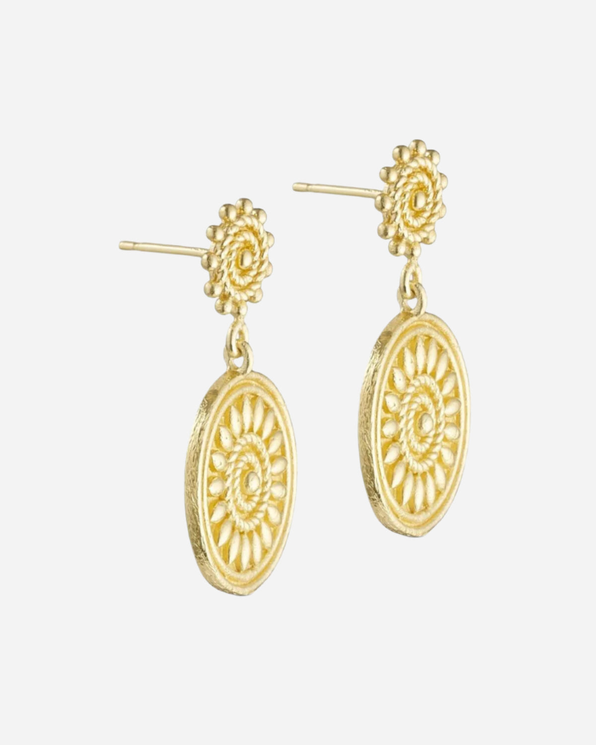 Gold earrings with floral top and circular bottom on a white background